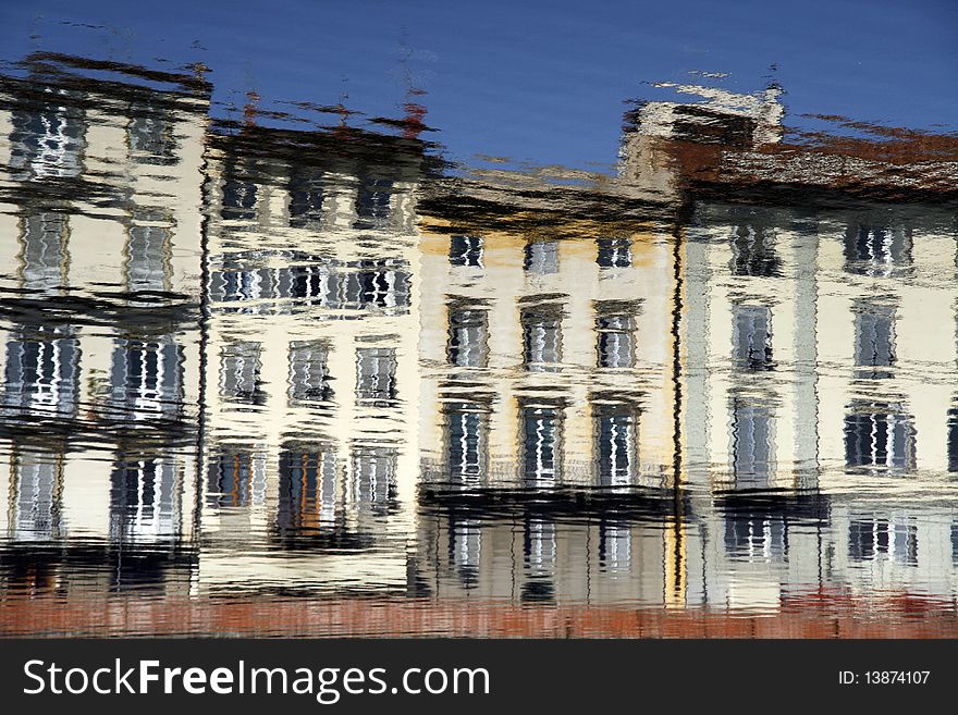 Water reflection of old tenements in Florence, Tuscany, Italy. Impressionistic style.