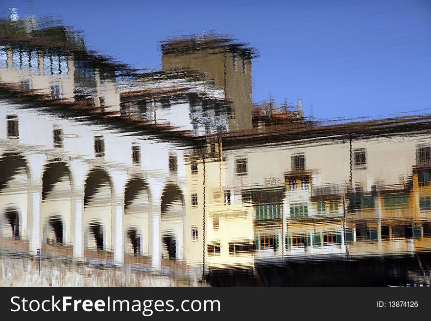 Water reflection of old bridge Ponte Vecchio in Florence, Tuscany, Italy. Impressionistic style.