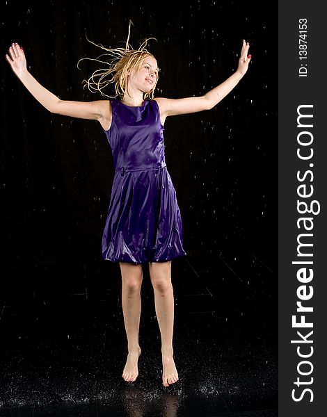 Full length portrait of a woman in water studio