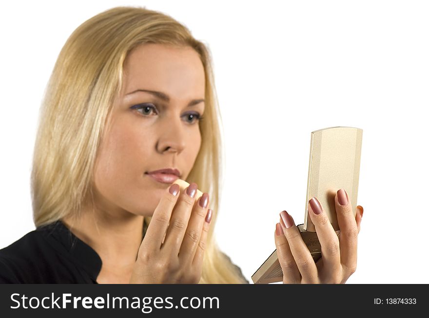 A beautiful woman touching up her make up. A beautiful woman touching up her make up