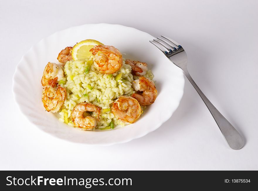 Risotto with fried prawns and avocado macro shot background