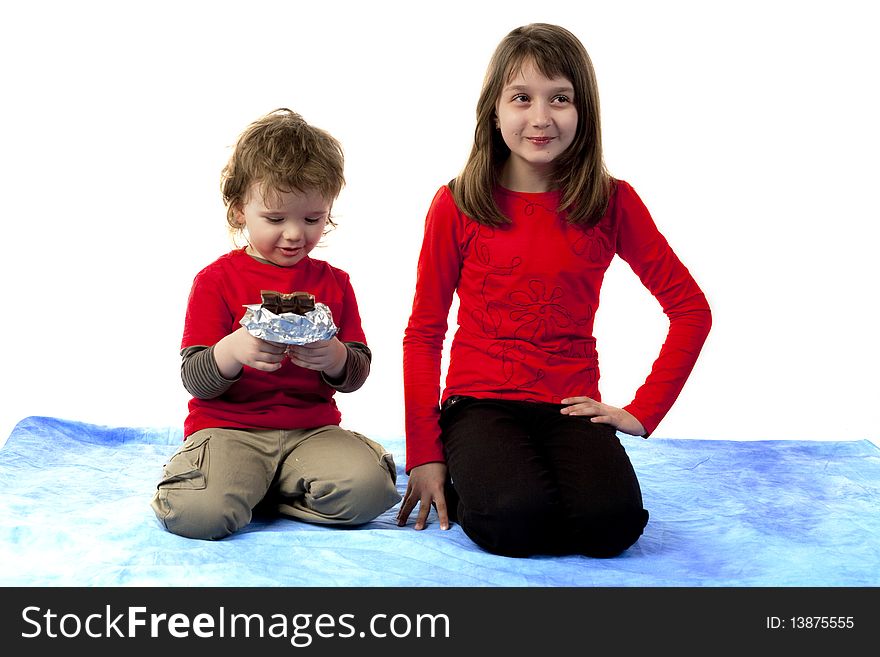 Child with chocolate and a girl looking away. Child with chocolate and a girl looking away