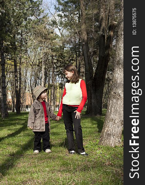 Cute couple of two children standing in a forest. Cute couple of two children standing in a forest
