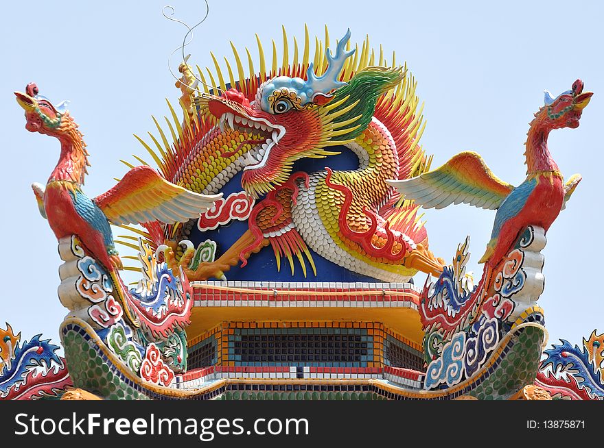 A chinese dragon with two phoenix