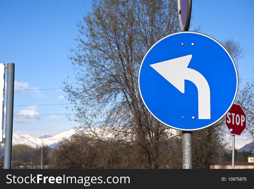 Road sign on mountain and tree background