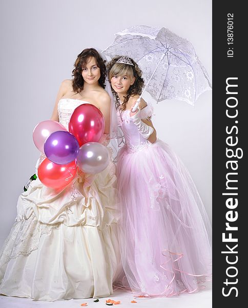 Portrait of the brides in a white dress with a diadem in hair in  studio. Portrait of the brides in a white dress with a diadem in hair in  studio