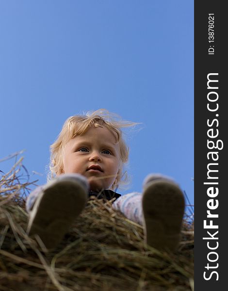 Little boy sitting on the hay