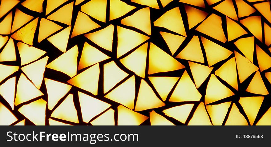 Many triangles making up a warm-colored mosaic