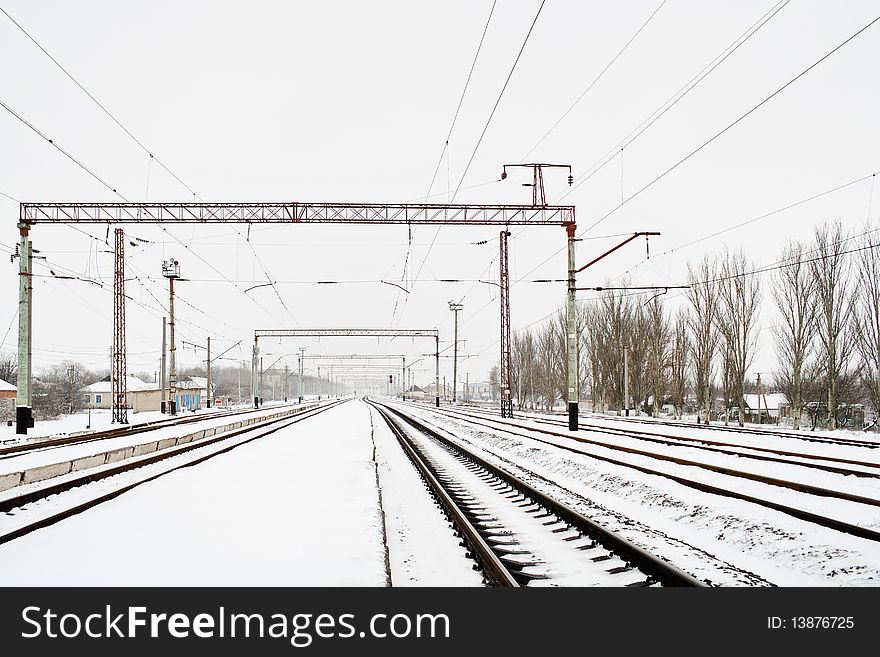 Snowy railways on railroad station in ukrainian village