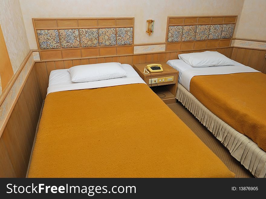 Twin beds neatly done up in a high class hotel room. Suitable for concepts such as travel, tourism, vacation and holiday. Twin beds neatly done up in a high class hotel room. Suitable for concepts such as travel, tourism, vacation and holiday.