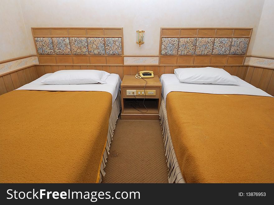 Twin beds neatly done up in a high class hotel room. Suitable for concepts such as travel, tourism, vacation and holiday. Twin beds neatly done up in a high class hotel room. Suitable for concepts such as travel, tourism, vacation and holiday.
