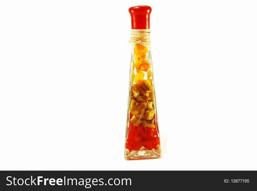 Decorative closed bottle with pepper inside on a white background. Decorative closed bottle with pepper inside on a white background
