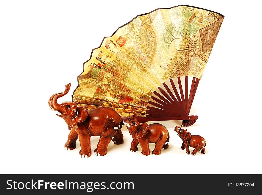 Three elephants and a Chinese fan isolated on a white background. Three elephants and a Chinese fan isolated on a white background