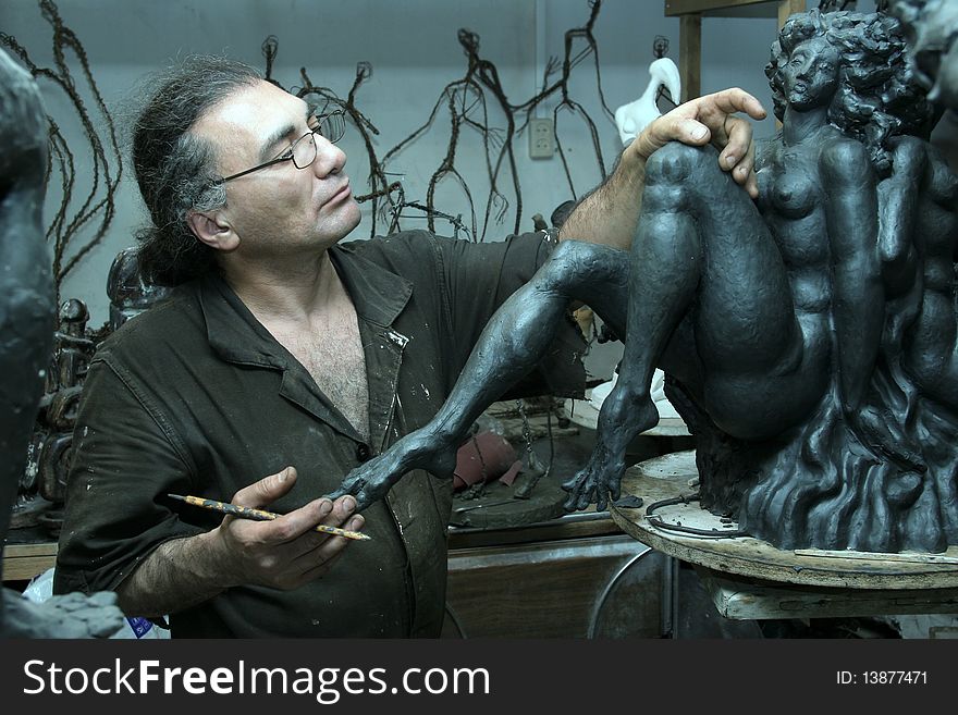 The sculptor works in a workshop