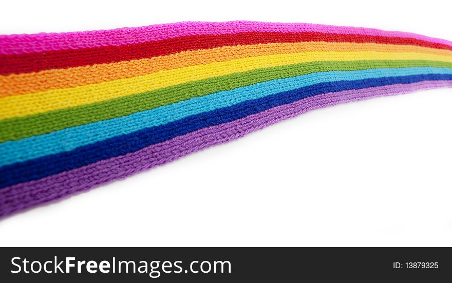 The image of a bright rainbow knitted scarf