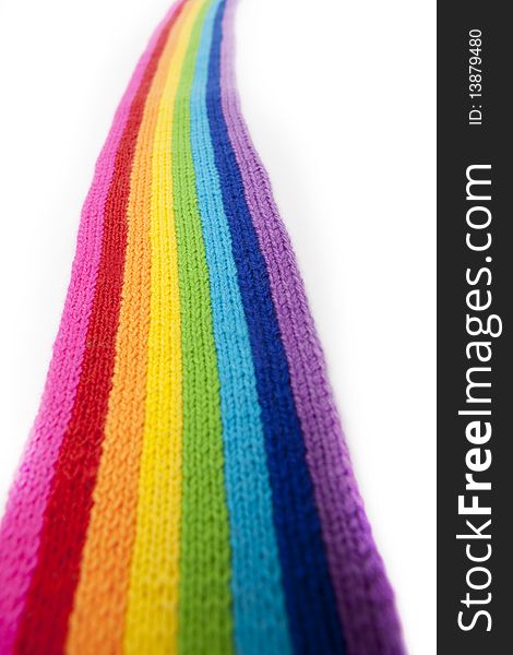 The image of a bright rainbow knitted scarf