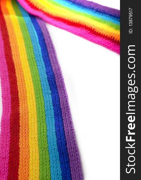 The image of a bright rainbow knitted scarf