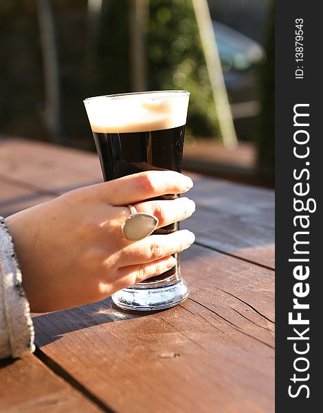 Glass of stout in a beer garden, Carlingford Ireland. Glass of stout in a beer garden, Carlingford Ireland