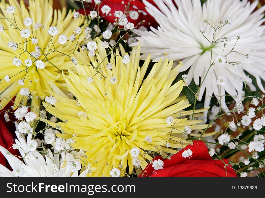 Beautiful bouquet with red roses and yellow asters