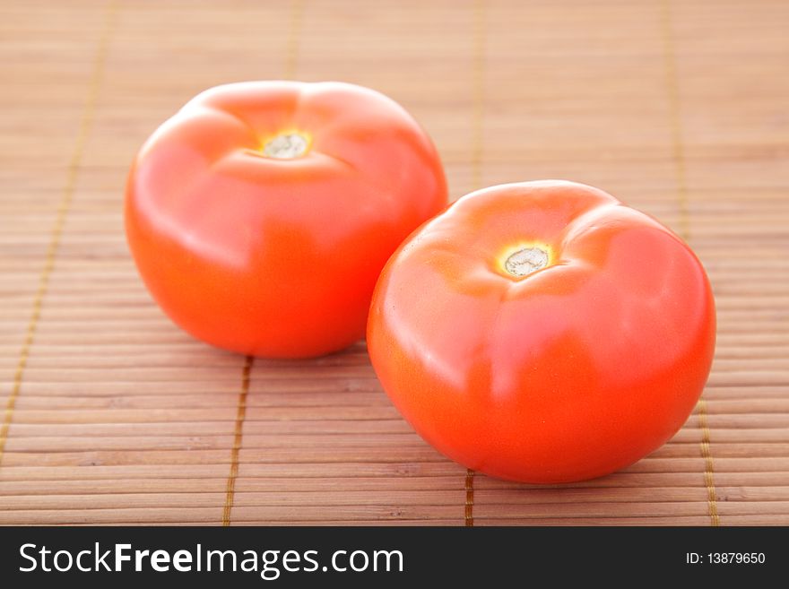 Red tomatoes obove bamboo napkin