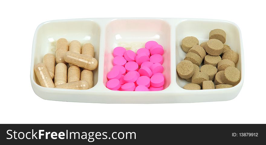 Capsules and pills on white background