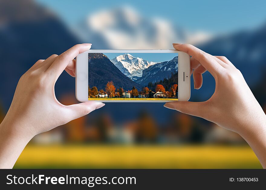 Hands take photo of nice mountain and sky scenery view with mobile smartphone