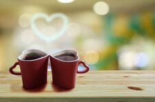 Black Coffee In Two Pink Cups Heart Shape With Smoke Is A Heart Shape On Wooden Floor And Colorful Bokeh Background Stock Image
