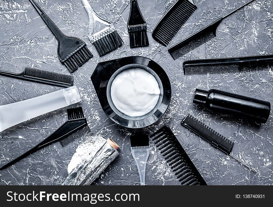 Barbershop concept with hairdye tools on gray table background top view
