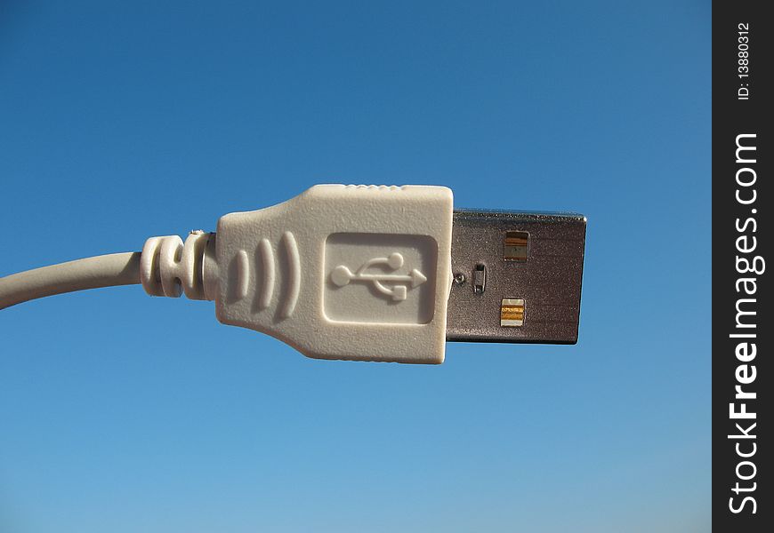 USB-connector on a background of blue sky