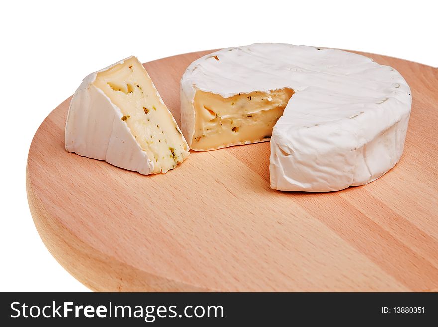 Round camembert block with cut out segment on wooden board over white background. Round camembert block with cut out segment on wooden board over white background.