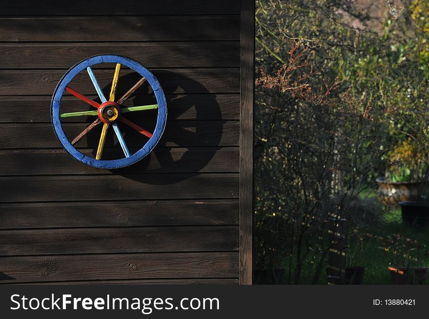 A wheel mounted on the outside of a garden house. Shot in this angle to look like a safety locker of a bank, but opens to nature. A wheel mounted on the outside of a garden house. Shot in this angle to look like a safety locker of a bank, but opens to nature