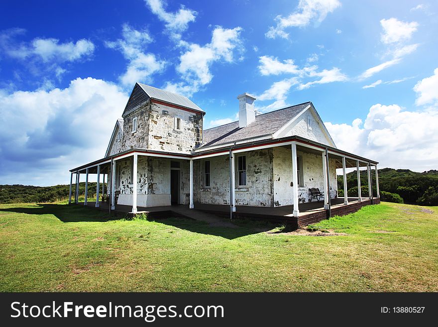 A small house with blue sky and clouds, shot in Cape Otway,Australia. A small house with blue sky and clouds, shot in Cape Otway,Australia