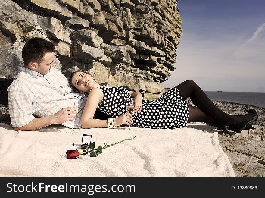 Engaged couple enjoing sunny day on the beach