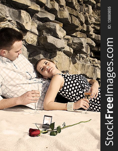 Engaged couple enjoing sunny day on the beach