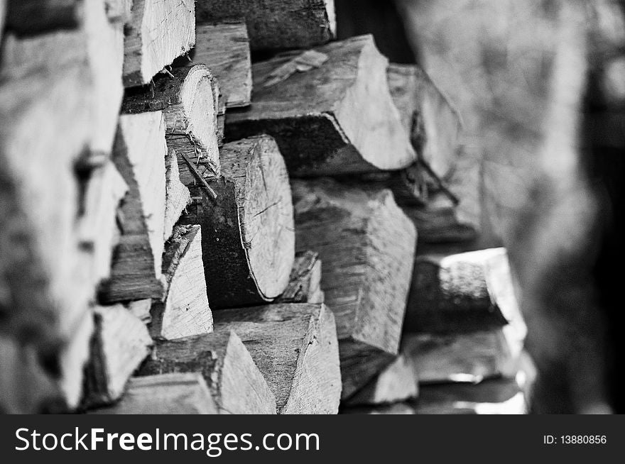B/W Pile or stack of chopped logs outdoors. B/W Pile or stack of chopped logs outdoors.