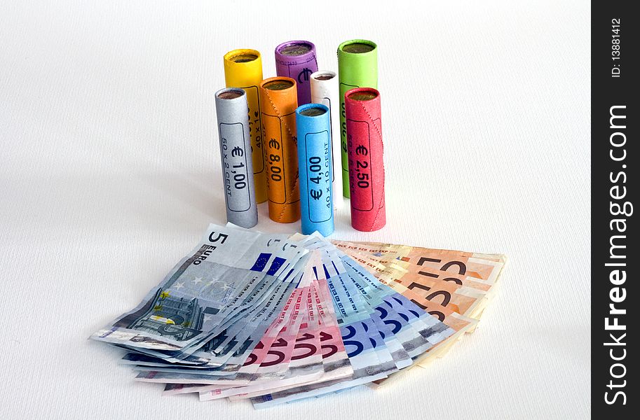 Euro notes and coins in colored packages. Euro notes and coins in colored packages