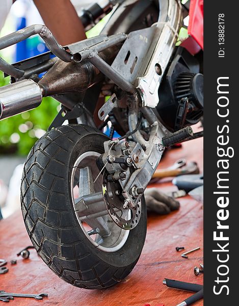 An image of a minibike being repaired. An image of a minibike being repaired