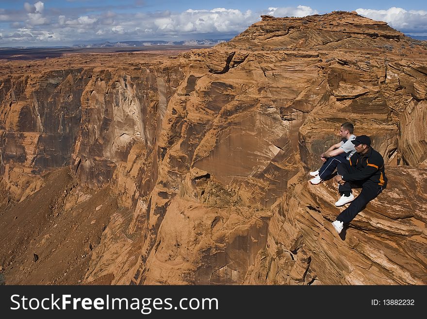 2 hikers resting at the top of a cliff in Arizona, USA. 2 hikers resting at the top of a cliff in Arizona, USA