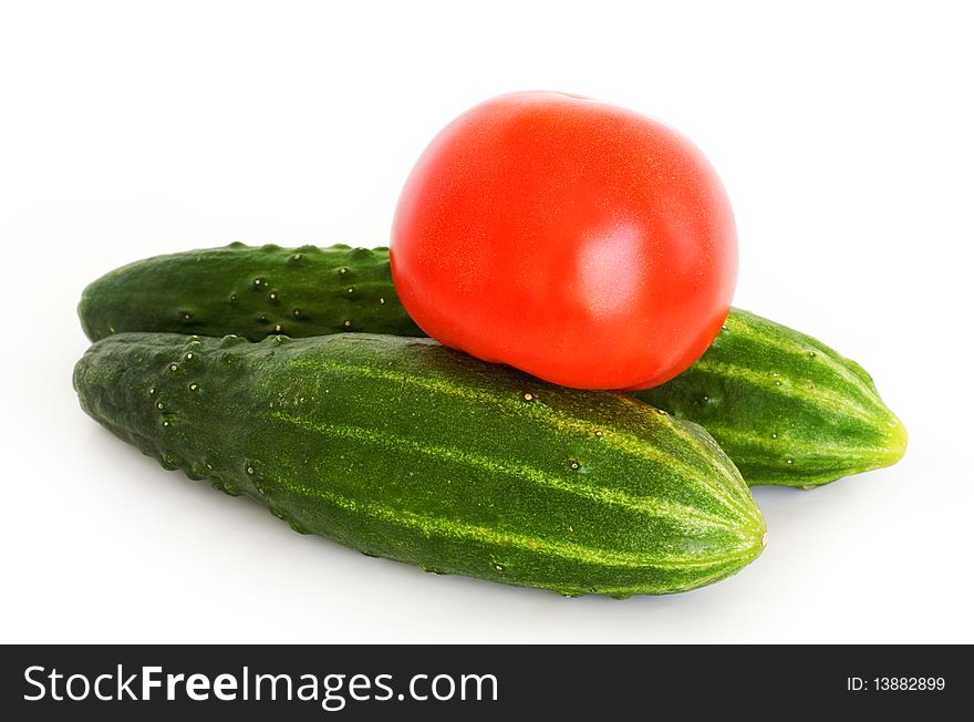 Fresh cucumbers and tomatoes on white background