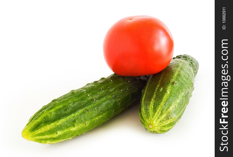 Fresh cucumbers and tomatoes on white background