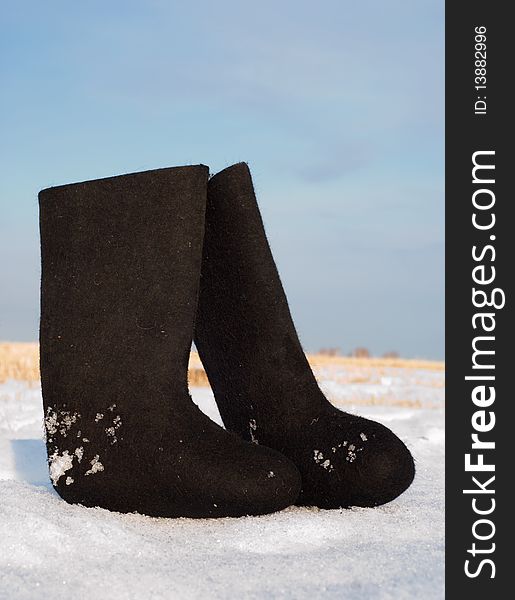Boots in the snow against the sky. Boots in the snow against the sky