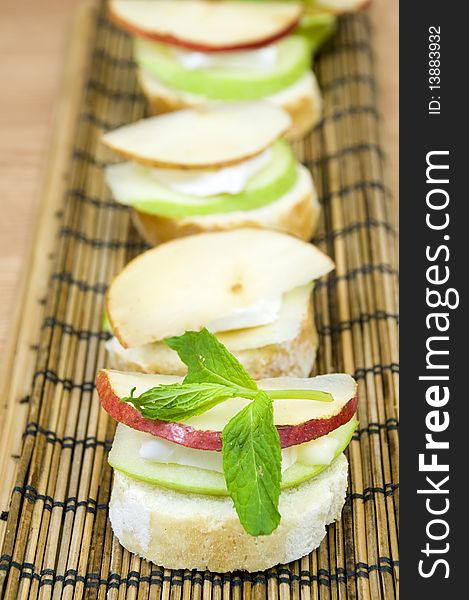 Canapes row, melting brie cheese and fresh organic fruits. Canapes row, melting brie cheese and fresh organic fruits