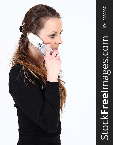 The attractive woman talks by a mobile phone