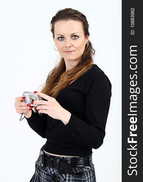 The attractive woman with digital camera on white background