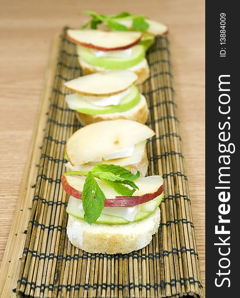 Delicious and fresh appetizer row, white cheese and apple. Delicious and fresh appetizer row, white cheese and apple