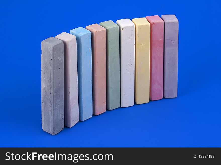 Colorful school chalk on blue background. Colorful school chalk on blue background