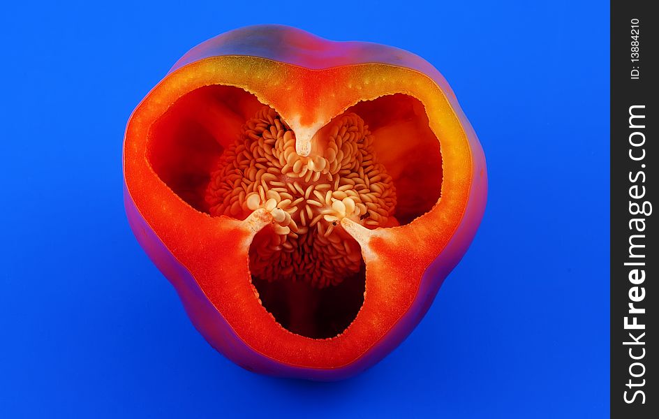 Sliced red pepper on a blue background