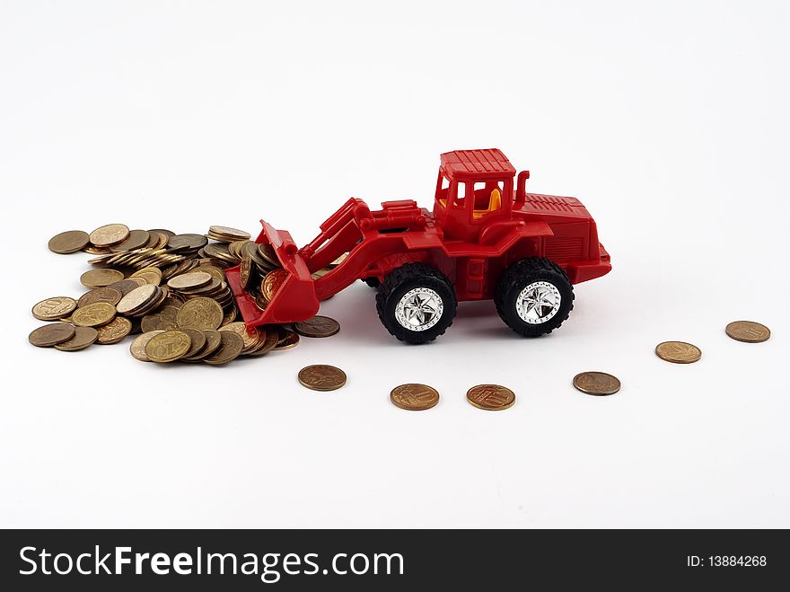 Red toy tractor rakes coins
