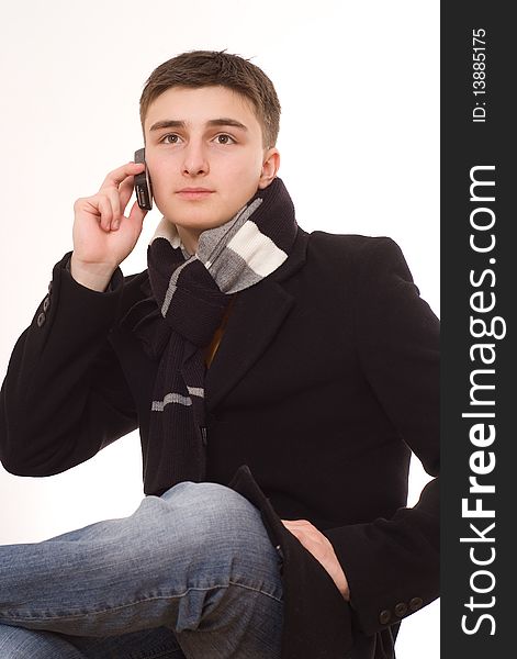 Handsome young man with a phone on a white background