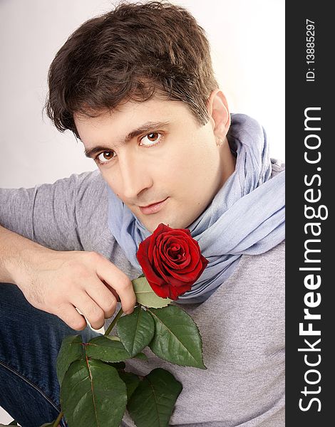 Young attractive smiling man with red rose, studio shot. Young attractive smiling man with red rose, studio shot